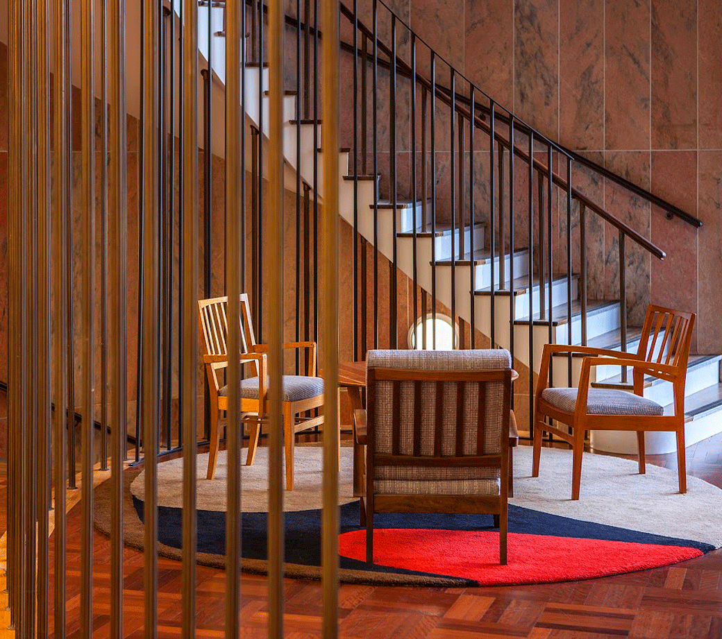 Picture of lobby and central stairwell ANU Florey Building with period furnishings.