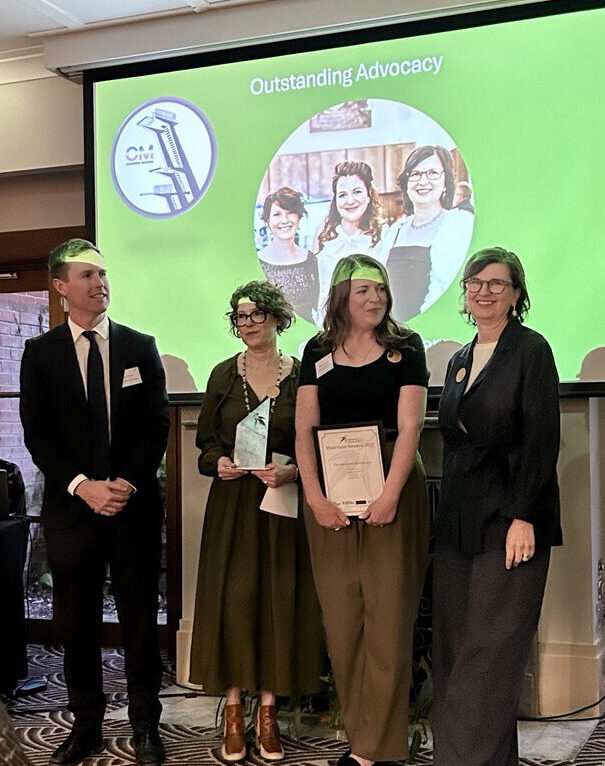 Canberra Modern's Edwina Jans, Amy Jarvis and Rachel Jackson receiving their Outstanding Advocacy Award from ACT Minister for Heritage Chris Steel.